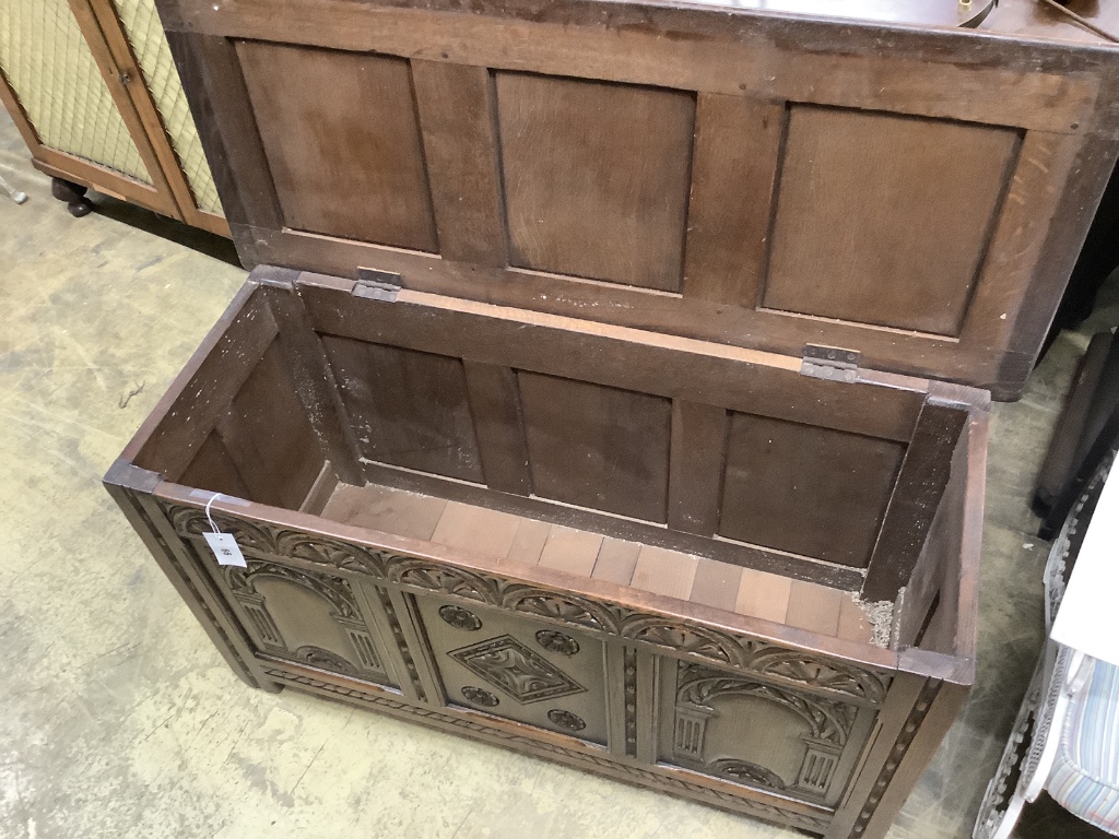 An 18th century style carved oak panelled coffer, width 105cm depth 45cm height 58cm